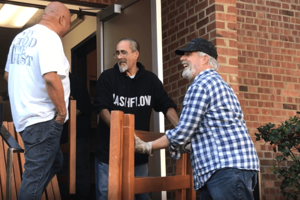 men take furniture out of a dorm building