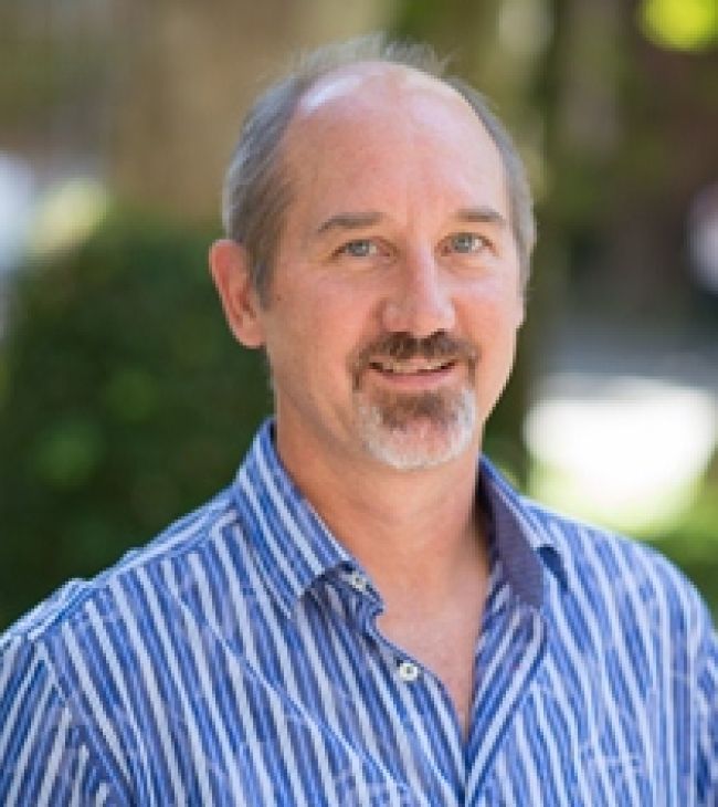 Photograph of Associate Dean Mic