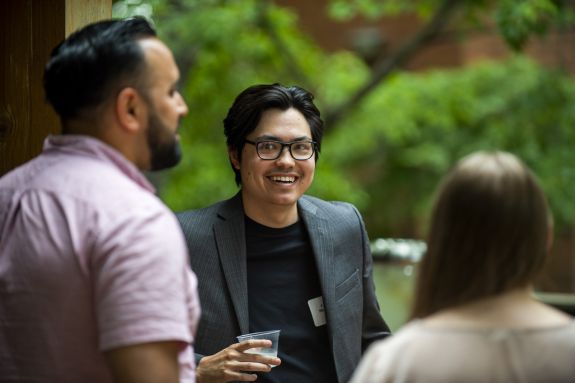 Three students chatting with each other