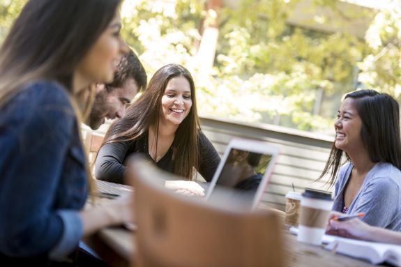 A group of law students sit outside.