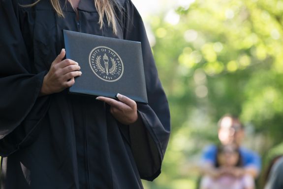 diploma held by graduate. 