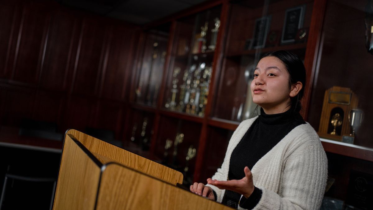 a student gives a speech at a podium