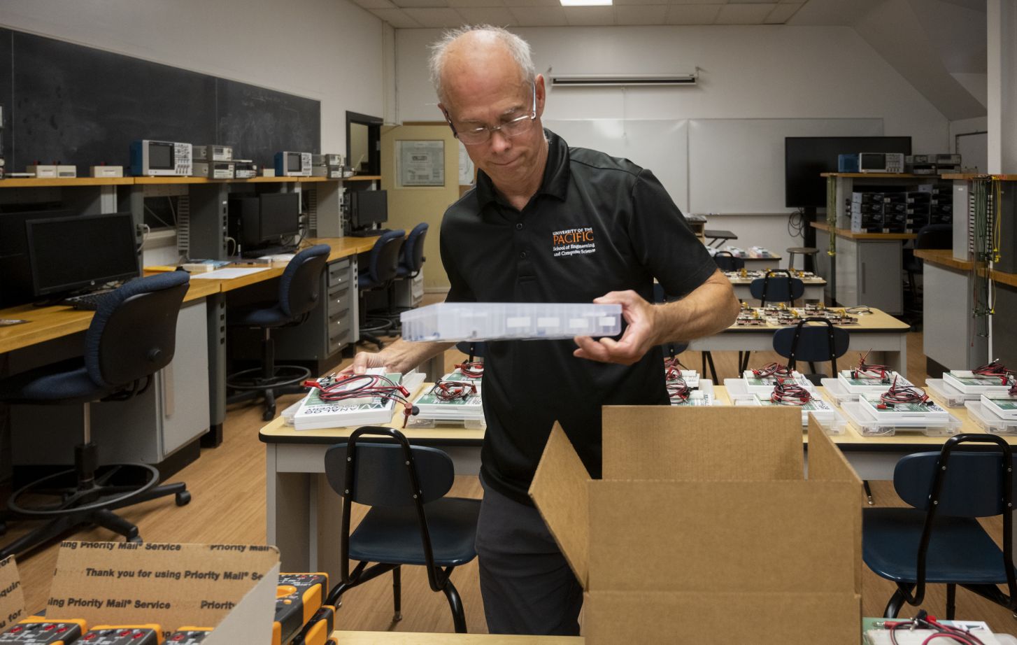 Mark Forman packing ECPE lab kits.