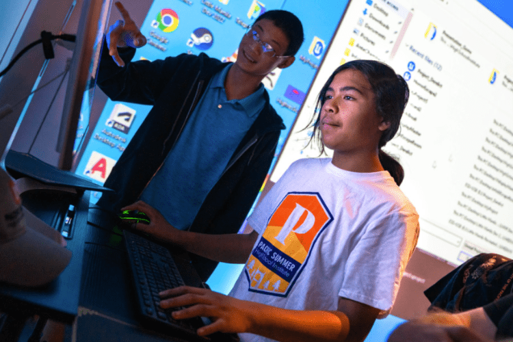 Two students looking at a computer 