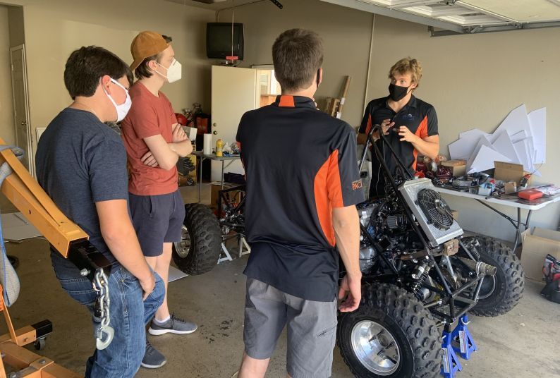 Students working on car