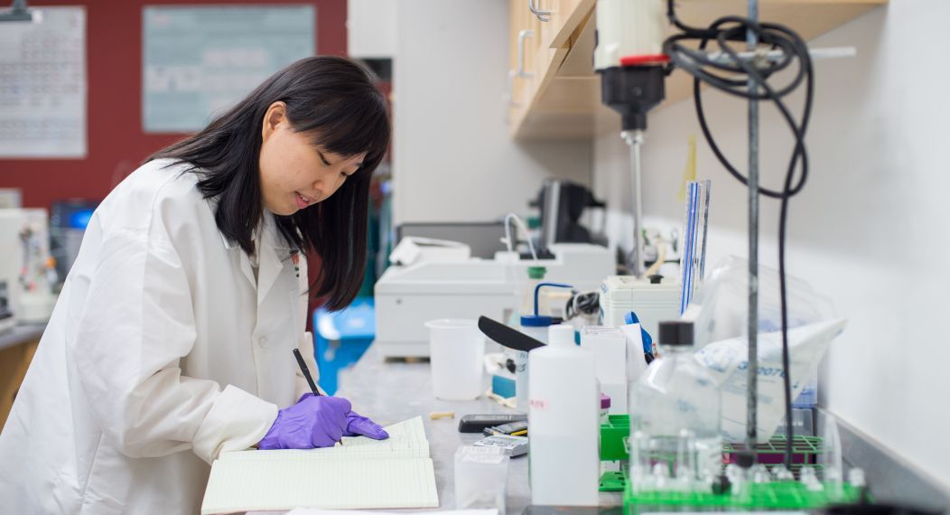 Student in bioengineering lab wearing a lab coat.
